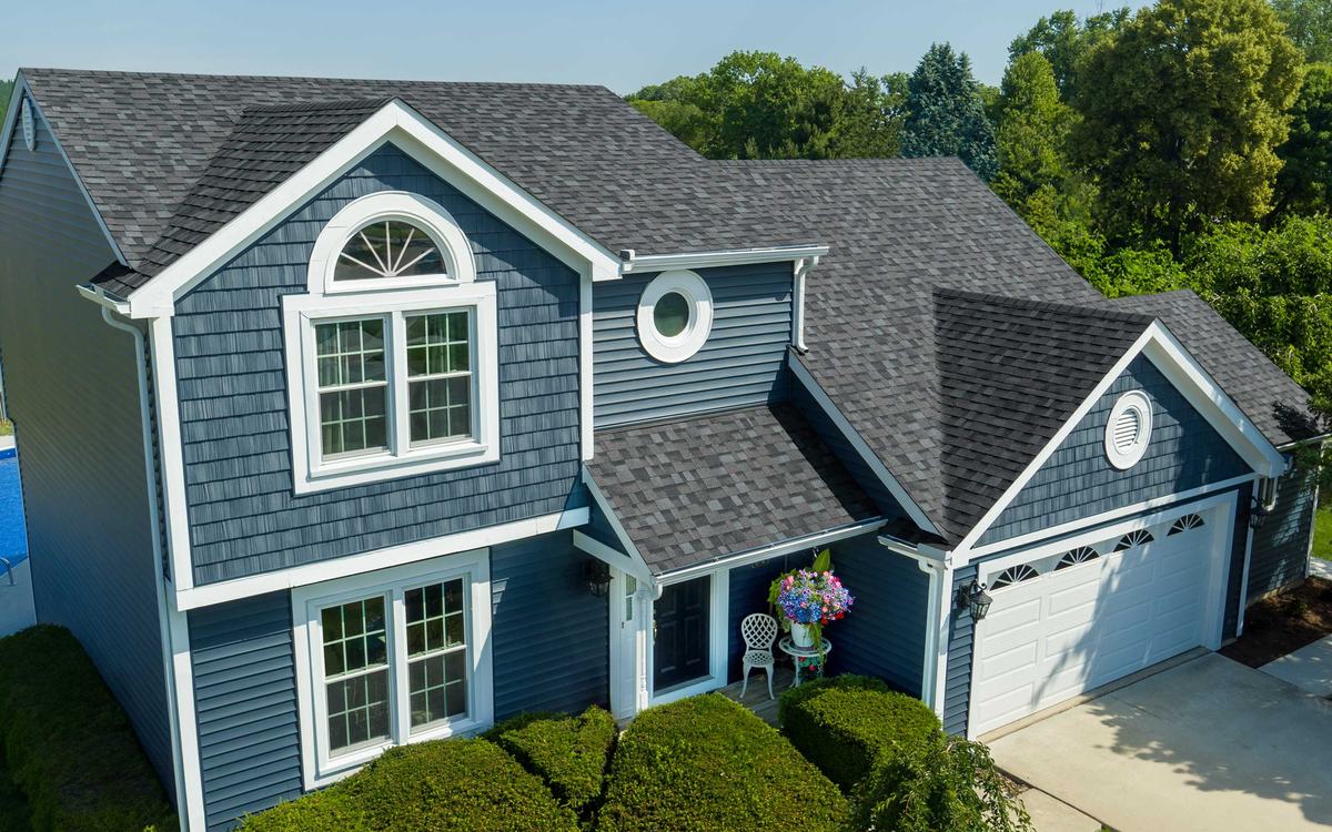 Gray shingle roof on a blue home